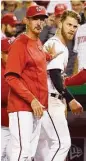  ?? Nick Wass / Associated Press ?? Nationals pitching coach Mike Maddux, left, holds back Bryce Harper after he was ejected Monday.