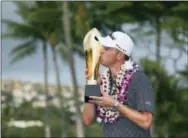  ?? MARCO GARCIA — THE ASSOCIATED PRESS ?? Justin Thomas kisses the trophy after winning the Sony Open golf tournament Sunday in Honolulu. Challenged only by the record book, Thomas won the Sony Open on Sunday with the lowest 72-hole score in PGA Tour history.