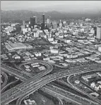  ?? George Rose
Los Angeles Times ?? AN AERIAL VIEW of the 10 and 110 freeways near downtown L.A., taken in 1980.