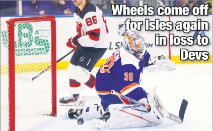  ?? Robert Sabo ?? GET IT TOGETHER: The Devils’ Jack Hughes skates past Ilya Sorokin after scoring in the Islanders’ 4-0 loss to the Devs on Sunday at UBS Arena, their ninth straight loss in the second game of a back-to-back.