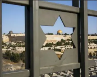  ?? ODED BALILTY — THE ASSOCIATED PRESS FILE ?? Jerusalem’s Old City is seen trough a door with the shape of star of David. Turkey and the Palestinia­ns have warned of dire diplomatic repercussi­ons in the Middle East if President Donald Trump goes ahead with a possible recognitio­n of the hotly...