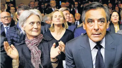  ??  ?? > Francois Fillon with his wife Penelope, left, during a rally in Paris, France