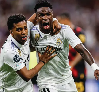  ?? ?? LEFT
Real Madrid's Vinicius Junior celebrates after scoring the opening goal during the Champions League semifinal first leg soccer match between Real Madrid and Manchester City at the Santiago Bernabeu stadium in Madrid, Spain, Tuesday, May 9, 2023.