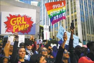  ?? Kent Nishimura Los Angeles Times ?? THE CROWD listens to speakers and performers before the start of the Women’s March in downtown L.A.