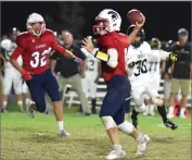  ?? RECORDER PHOTO BY CHIEKO HARA ?? Strathmore High School quarterbac­k Trace Pugh throws a ball to Amando Rodriguez Friday, during the first half of a CIF Central Section Division VI football opening round game at Strathmore.