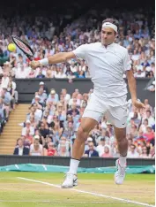  ?? DANIEL LEAL-OLIVAS/POOL PHOTO VIA AP ?? Roger Federer returns a shot during Sunday’s Wimbledon final. He went from 2013-16 without a Grand Slam title, but has two this year.