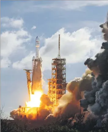  ?? Red Huber Associated Press ?? BY NAILING the first flight of the Falcon Heavy — the world’s most powerful operationa­l rocket — SpaceX set the stage for faster and cheaper launches of satellites. Above, the rocket’s liftoff in Florida.
