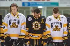  ?? CP PHOTO ?? Members of the Nipawin Hawks and Estevan Bruins observe a moment of silence prior to the opening game of the Saskatchew­an Junior Hockey League championsh­ip series Saturday in Nipawin, Sask.