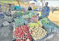  ?? AFP ?? A man shops for produce from a vegetable stall in the Jarif West district of Khartoum, Sudan on Monday.