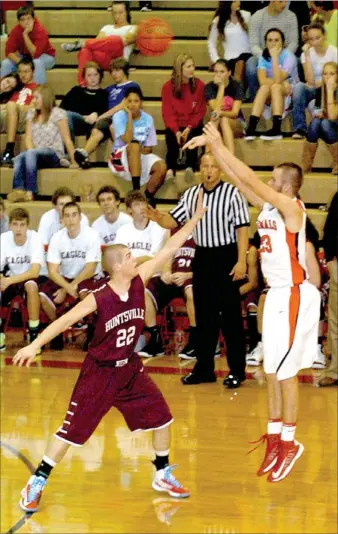  ?? MARK HUMPHREY ENTERPRISE-LEADER ?? Farmington senior Matt Brackett launches a 3-point shot from well behind the arc. The Farmington boys basketball squad is 4-3 on the young season despite a 56-50 loss to Huntsville on Friday.