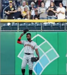  ?? GENE J. PUSKAR — THE ASSOCIATED PRESS ?? San Francisco’s Andrew McCutchen acknowledg­es fans as he takes right field for the first inning of his first game back in Pittsburgh on Friday.