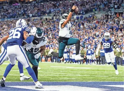  ?? TREVOR RUSZKOWSKI/USA TODAY SPORTS ?? Eagles quarterbac­k Jalen Hurts scores the game-winning TD in the fourth quarter against the Colts at Lucas Oil Stadium.