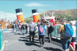  ??  ?? Passengers keep socially distant as they embark on their north Arran cruise.