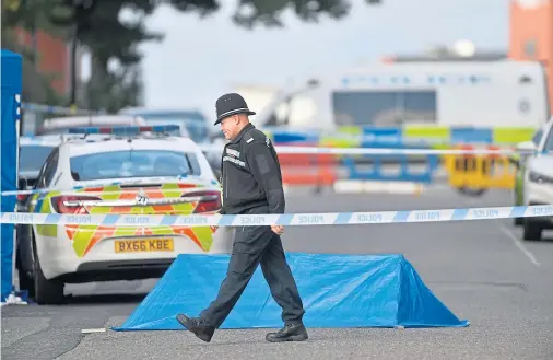  ??  ?? MAJOR INCIDENT: A police officer at a cordon in Irving Street, Birmingham after a man died and seven others were injured yesterday