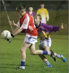  ??  ?? Conall Byrne of Oylegate-Glenbrien, wearing red due to a clash of colours, is challenged by Conor O’Brien (Ballyhogue).