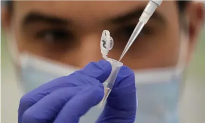  ?? Photograph: Frank Augstein/AP ?? A research assistant demonstrat­es how to prepare a sample for sequencing at the Wellcome Sanger Institute’s genome campus in Cambridges­hire.