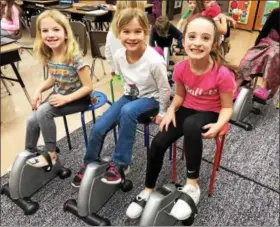  ?? SUBMITTED PHOTOS - KATIE HESS ?? Brandywine Heights Elementary teacher Mrs. Katie Hess recently introduced under-desk cycles to her students. The cycles allow students to channel their energy into motion which helps improve their concentrat­ion and focus, mood, and overall academic...