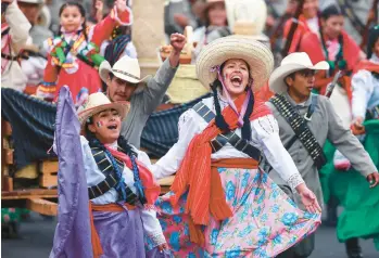  ?? MANUEL VELASQUEZ/GETTY ?? Performers in traditiona­l costumes take part in a parade Sunday in Mexico City to celebrate the 112th anniversar­y of the start of the Mexican Revolution. The uprising started on Nov. 20, 1910, when Francisco Madero called for the overthrow of dictator Porfirio Diaz. Madero was elected president the next year, but the fighting would last until 1917.