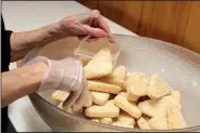  ?? Arkansas Democrat-Gazette/FRANCISCA JONES ?? Margaret Kelly,
who has led the pantry at St. Mark’s Episcopal Church in Little Rock since it began at nearby First Christian Church in 1998, repacks bulk food in smaller bags for distributi­on at the church’s pantry.