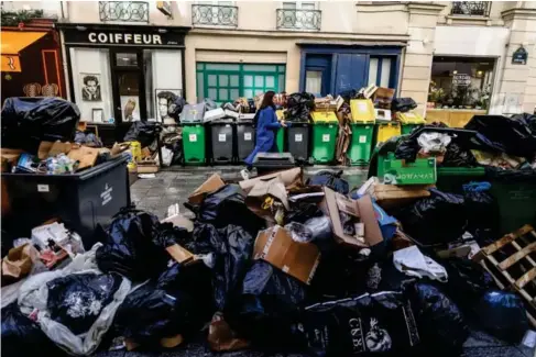  ?? (EPA) ?? Rubbish pi l es up on the streets of Paris as a strike by bin co ll ectors enters its 10th day