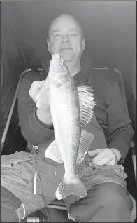  ?? Simonson Photo. ?? The author’s friend, Josh Holm of Valley City, ND, with a walleye pulled up from under the ice and observed by the author on high-end sonar the whole time.