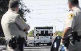  ?? Richard Brian ?? Las Vegas Review-journal @vegasphoto­graph Las Vegas police cordon off roads Tuesday near West Charleston Boulevard and South Cimarron Road. Police shot and killed a man Tuesday morning inside an apartment.