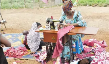  ?? PHOTO: ?? An Internally Displaced Person (IDP) makes clothes to empower herself economical­ly at the IDPs Camp in Durumi, Abuja Abubakar Yakubu