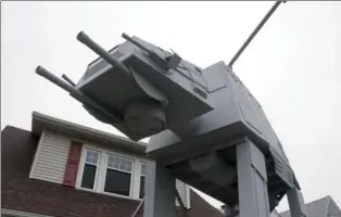  ?? PHOTOS BY PATRICK COOLEY, THE PLAIN DEALER-CLEVELAND.COM VIA AP ?? A replica four-legged All Terrain Armored Transport, or AT-AT walker in Parma, Ohio. Owner Nick Meyer tells Cleveland.com he used wood, hard foam and plastic barrels. He says he enjoys the “Star Wars” movies but isn’t a fanatic and simply thought the...