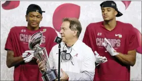  ?? CARMEN MANDATO — THE ASSOCIATED PRESS ?? Alabama coach Nick Saban raises the trophy after defeating Notre Dame in a College Football Playoff semifinal Friday. He hopes to lead the Crimson Tide to their fourth national championsh­ip in six years Monday, but they must knock off Ohio State.