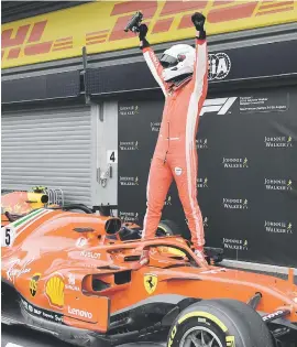  ?? Picture: AFP ?? VICTOR. Sebastian Vettel stands on his car in the pits after winning the Belgian Grand Prix at Spa-Francorcha­mps yesterday.