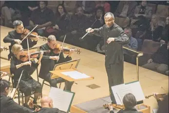  ?? Photograph­s by Nicholas Agro For The Times ?? THOMAS WILKINS conducts the L.A. Phil during a program featuring the work of William Grant Still.