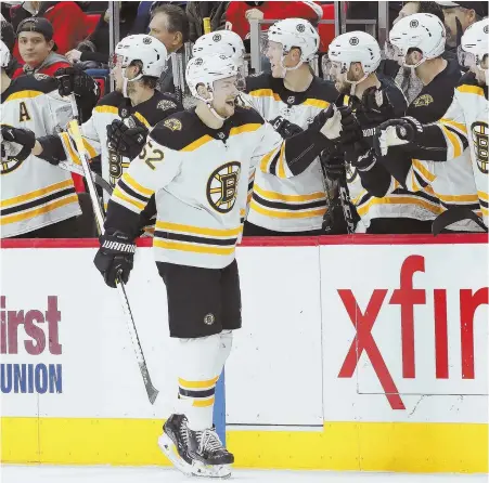  ?? APPHOTO ?? MOTORING: Sean Kuraly celebrates with the Bruins bench after his goal helped erase an early deficit and sparked last night’s 3-2 victory against the Red Wings in Detroit.