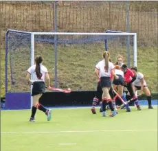  ??  ?? The Western Wildcats scramble in the goal area to prevent Anne Watts from scoring again.