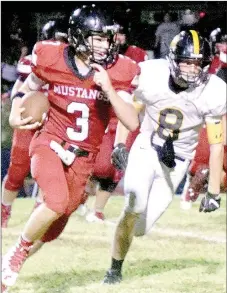  ?? PHOTO BY RICK PECK ?? McDonald County quarterbac­k Peyton Barton gets outside of Cassville’s Braden Strahan for a nice gain during the Mustangs 33-22 loss Friday night at MCHS.