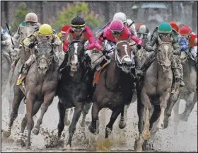  ?? John Minchillo The Associated Press ?? Luis Saez riding Maximum Security, second from right, goes around Turn 4 with Flavien Prat riding Country House, left, during Saturday’s running of the Kentucky Derby.