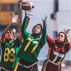  ?? AFP ?? Egyptian American football players from the AUC Titans (red) play against Gezira Thunder (green) during their match at the Maadi Olympic Centre in southern Cairo.