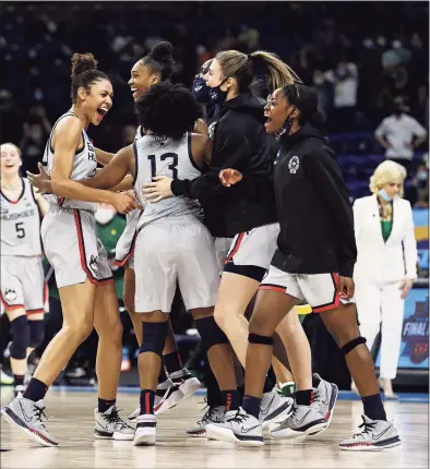  ?? Elsa / Getty Images ?? UConn celebrates the win over Baylor after the Elite Eight round of the Women’s NCAA Tournament at the Alamodome on Monday in San Antonio, Texas. UConn defeated Baylor 69-67 to advance to the Final Four.