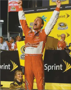  ?? Terry Renna/AP ?? Kevin Harvick celebrates winning the NASCAR Sprint Cup championsh­ip series auto race, Sunday, Nov. 16,2014 in Homestead, Fla.