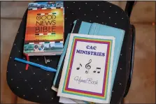  ?? (AP/Brian Inganga) ?? A hymn book and Bible are seen Oct. 17 during a church service at the Cosmopolit­an Affirming Community church.