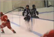  ?? THOMAS NASH — DIGITAL FIRST MEDIA ?? Hill School’s Jay Luce dumps the puck into the zone during the first period against Lawrencevi­lle.