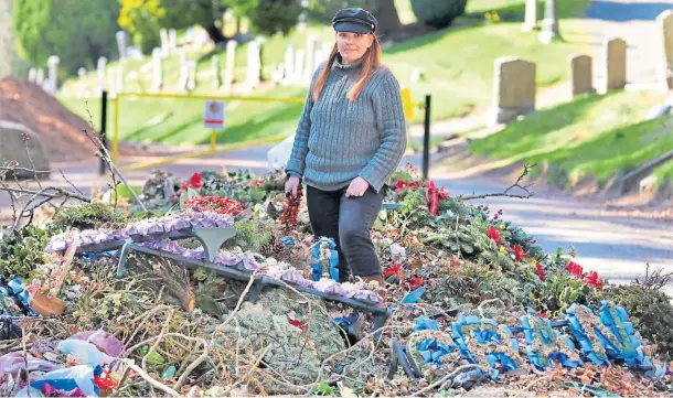  ??  ?? WASTE: Sarah Proctor, at Balgay Park beside the cemetery, is highlighti­ng the large number of plastic flowers and wreaths going to landfill.