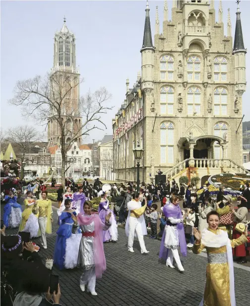  ?? Yomiuri Shimbun photos ?? Visitors watch a parade commemorat­ing the 30th anniversar­y at Huis Ten Bosch in Sasebo, Nagasaki Prefecture, on March 25.