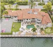  ?? SWIFT PIX/COURTESY ?? Formerly owned by NBA star Scottie Pippen, a home in Harbor Beach features a resort-style pool with a water slide, a putting green, a dock, an outdoor kitchen and a full NBA basketball court.
