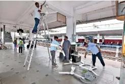  ?? — P. SURENDRA ?? Railway employees replace fans that were damaged during last Friday’s violence at Secunderab­ad railway station, on Sunday.