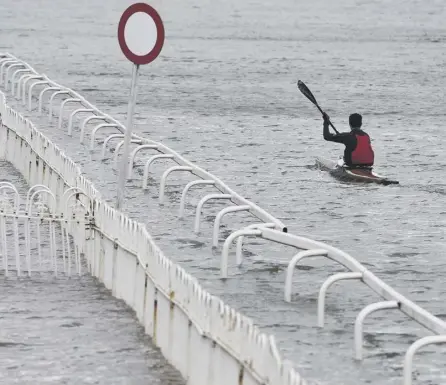  ??  ?? A member of Worcester Canoe Club kayaking on a flooded Worcester Racecourse at the weekend