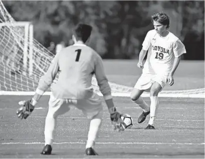  ?? KENNETH K. LAM/BALTIMORE SUN ?? Loyola Blakefield’s John Peterson lines up a shot against McDonogh goalie Kieran Baskett during the first half of the Dons’ victory. Peterson scored all three Loyola goals against the Eagles in an MIAA A Conference showdown Tuesday afternoon.