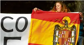  ??  ?? DIVIDED SPAIN A Spanish girl holds a Franco-era flag of Spain outside the Valle de los Caidos in Spain on Oct. 24.—REUTERS
