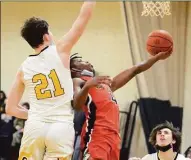  ?? Dave Phillips / For Hearst Connecticu­t Media ?? Christian McClease of Wilbur Cross scoops a shot off the glass during a game against Hand this season.