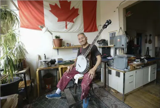  ??  ?? Pat King with his banjo in his workshop apartment.