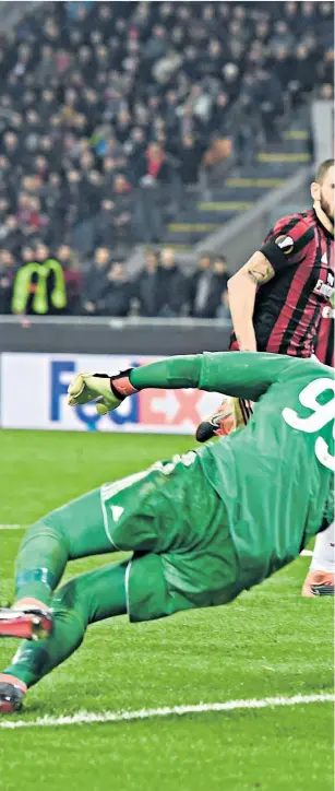  ??  ?? Finishing touch: Aaron Ramsey takes ball around AC Milan keeper Gianluigi Donnarumma to score Arsenal’s second